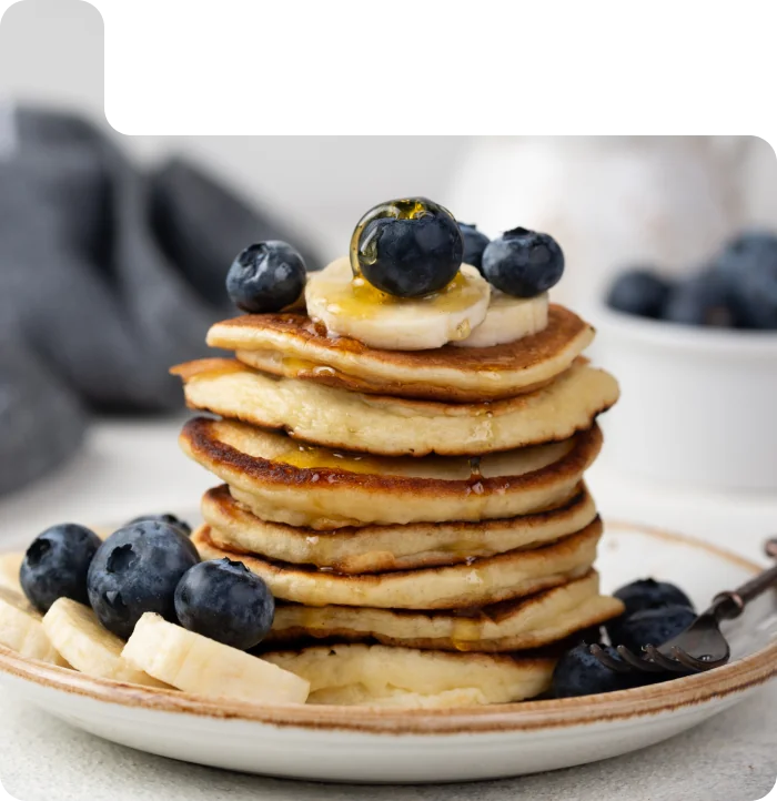 French toast topped with blueberries, raspberries, butter and powdered sugar